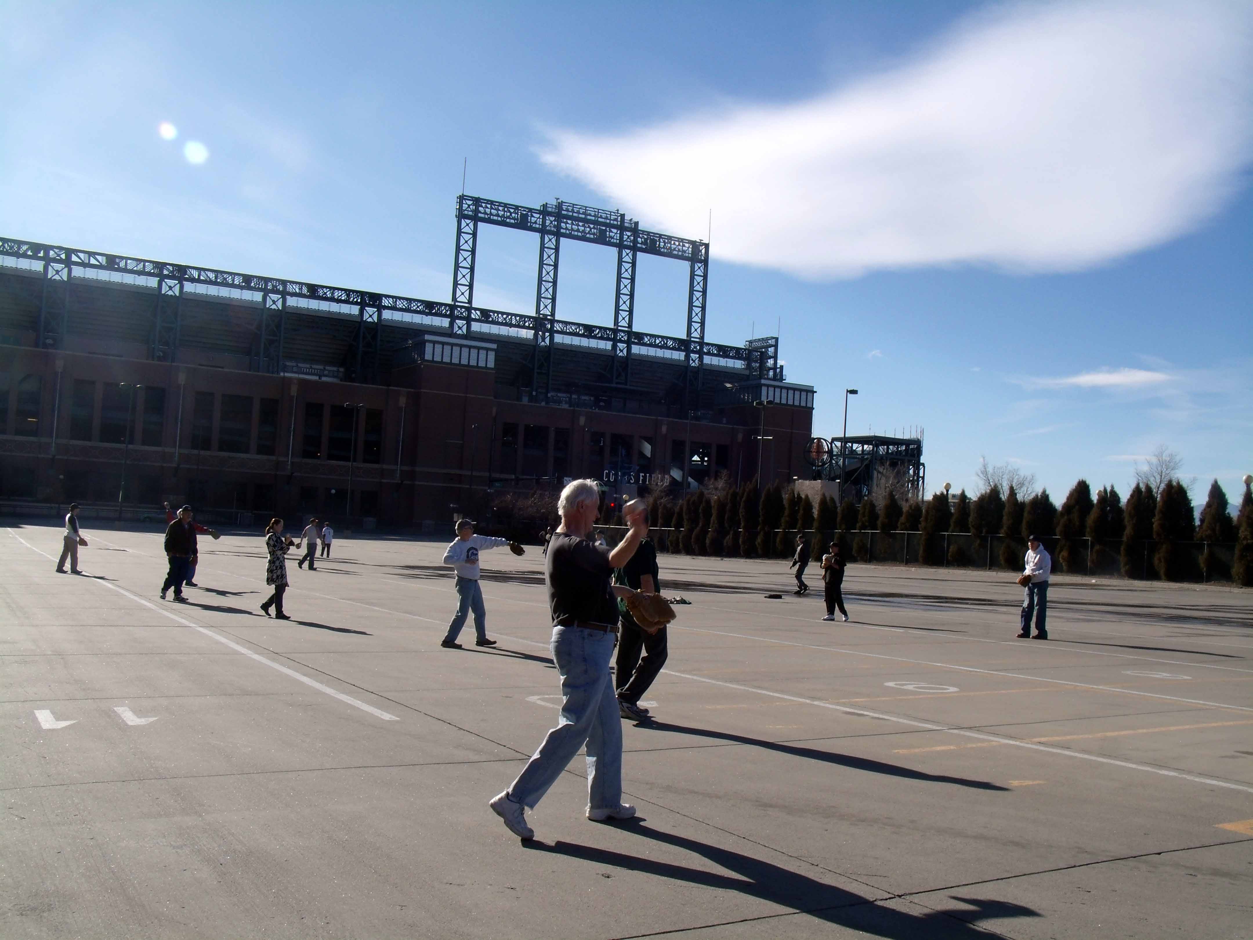 SABR members play catch in the parking lot outside Coors Field.